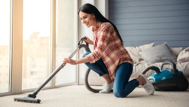 Lady cleaning carpet floor | Bodamer Brothers Flooring